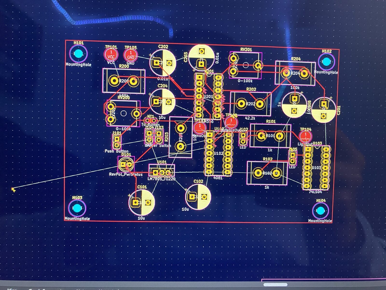 The layout in KiCad — pads, traces and mounting holes, before any copper existed.